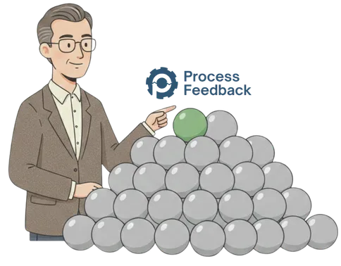 Man pointing at a green ball in pile of grey balls.